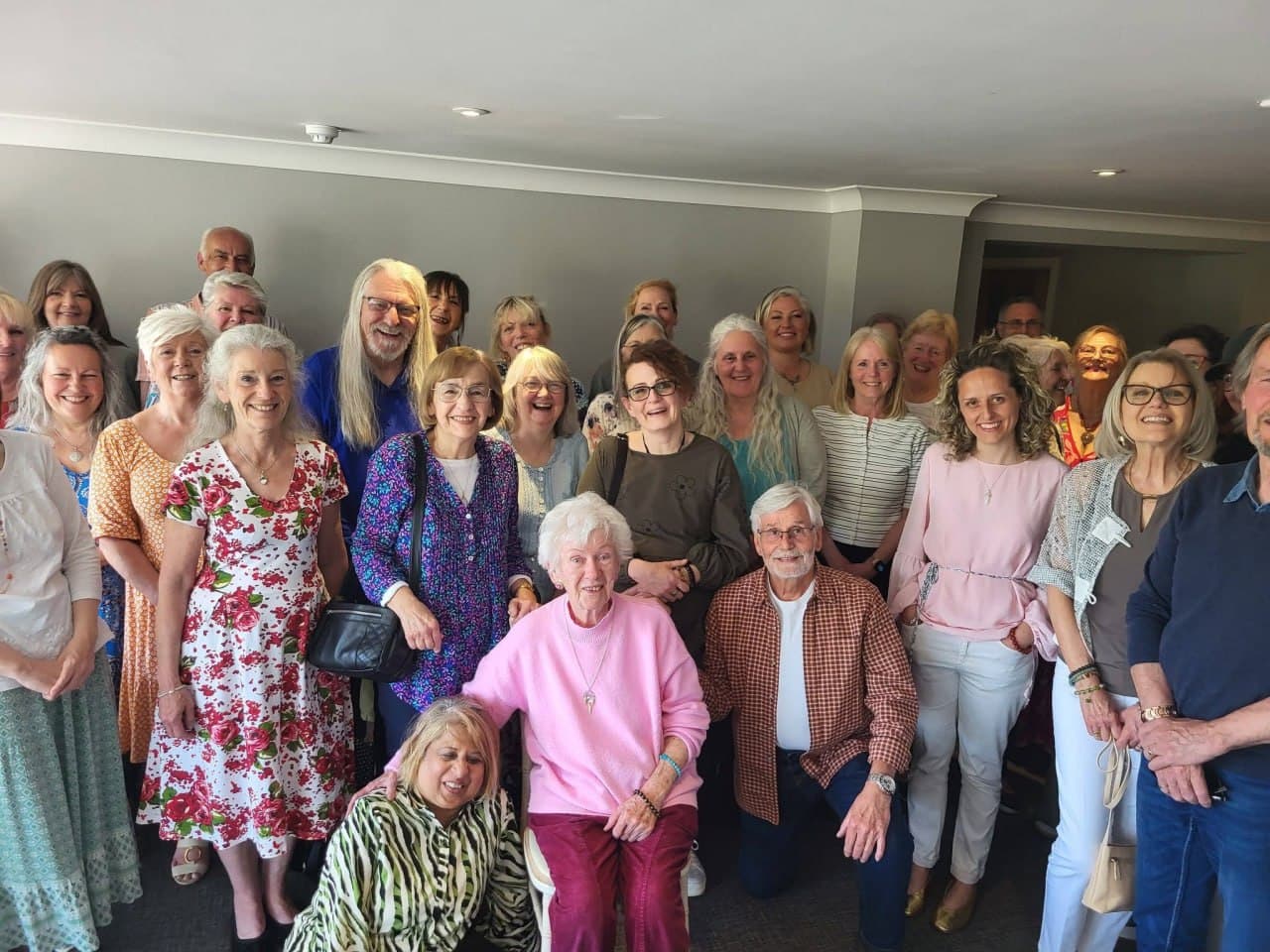A large group of Lightworkers Lunch guests smiling together