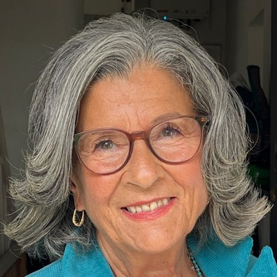 Sheela Hagan smiling in her turquoise jacket